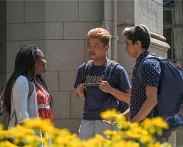 Pitt students talk just outside of the Cathedral of Learning.