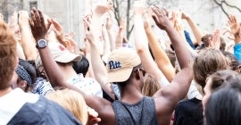 Students holding their hands in the air
