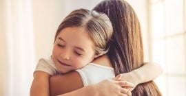 Woman and daughter hugging 