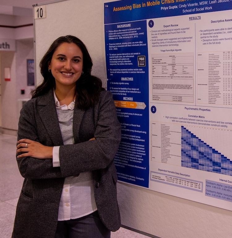 student in front of poster presentation